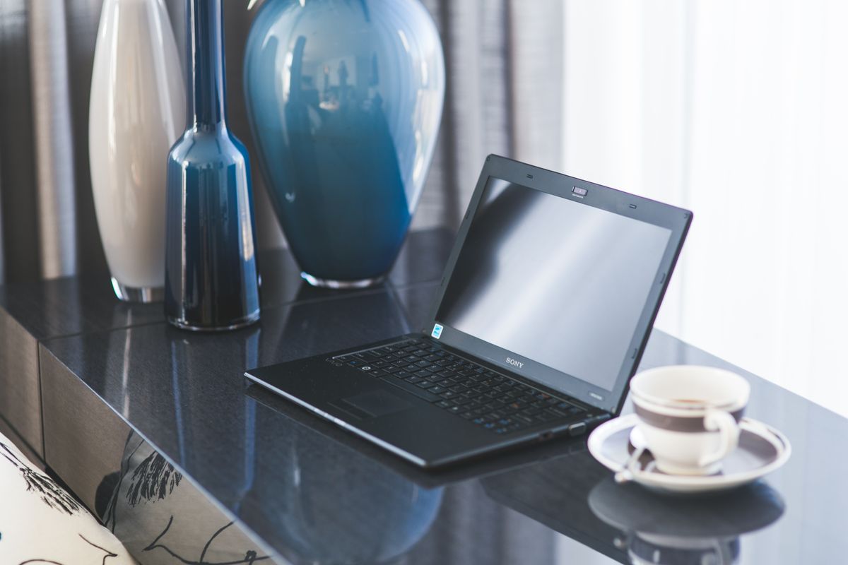 Laptop and coffee on a home office desk